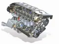 Przekrój silnika m57 z turbosprężarką, tłokami i wałkami rozrządu. Widoczne detale mechaniczne.