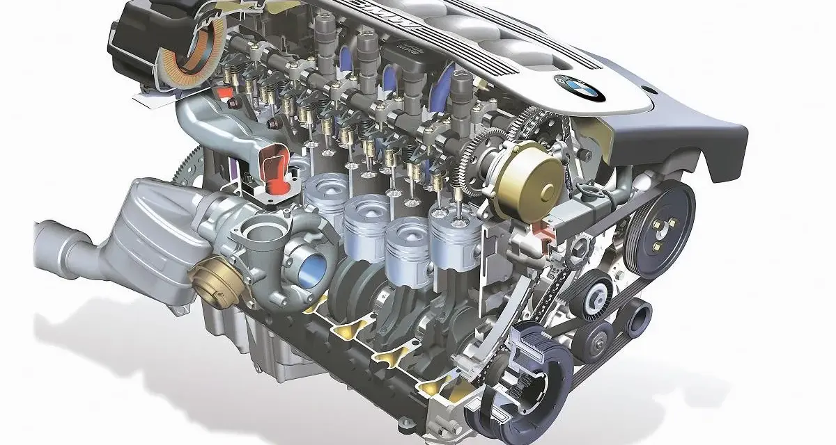 Przekrój silnika m57 z turbosprężarką, tłokami i wałkami rozrządu. Widoczne detale mechaniczne.
