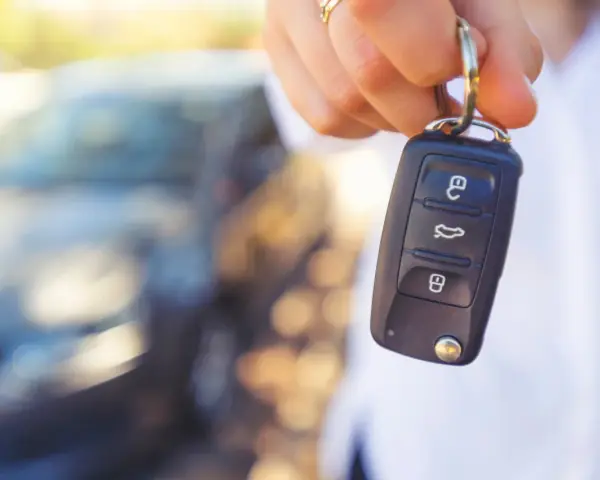 Dłoń trzyma kluczyk samochodowy. Gdyby wystąpiły uszkodzony immobilizer objawy, auto mogłoby nie odpalić.